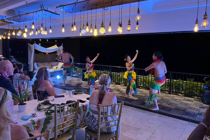 a group of people performing on stage in front of a fence