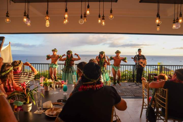 a group of people performing on stage in front of a table